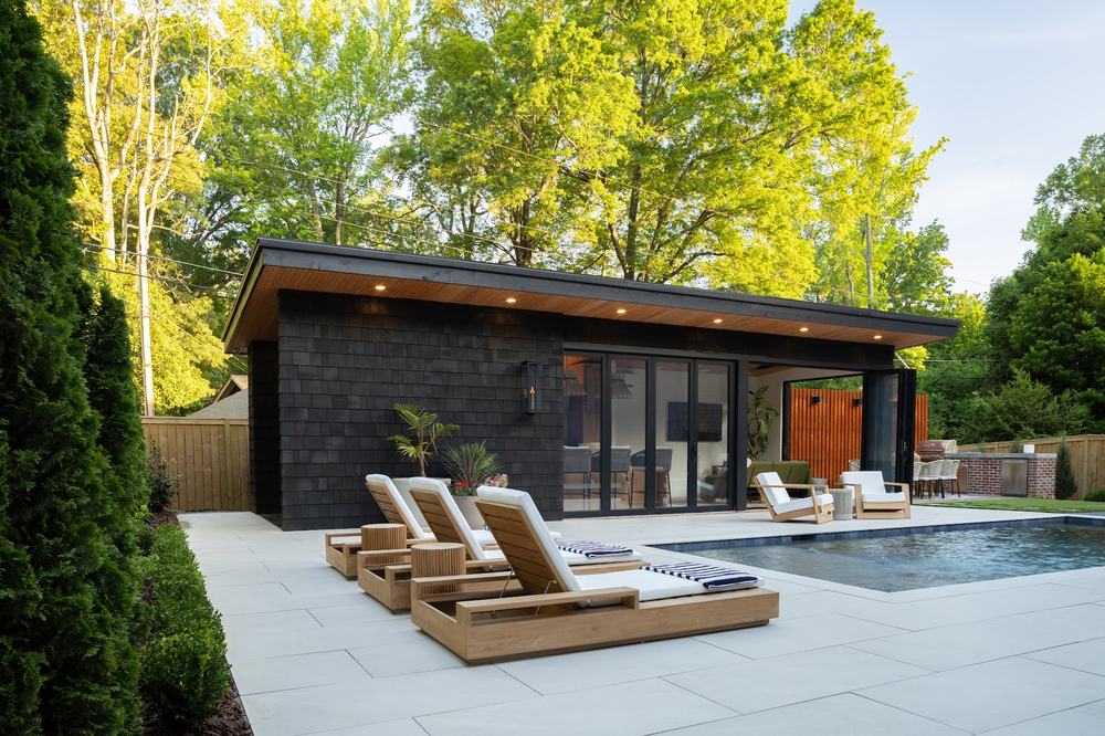 Indoor-outdoor pool house at dusk with integrated lighting and audio, Charlotte NC